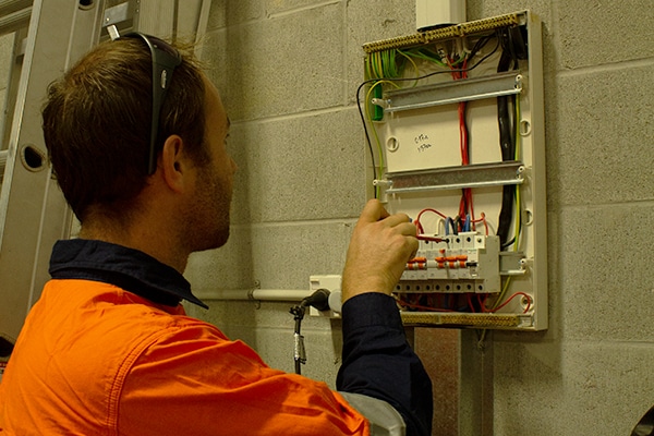 Electrician checking fuse box